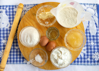 Getting ready for baking. Baking ingredients and kitchen utensils. Kitchen utensils, flour, eggs, sugar, honey, butter, salt, sour cream. necessary ingredients. at home. all you need for baking buns.