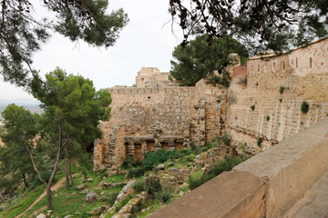 Road under the wall of old medieval Sagunto fortress, Valencia, Spain