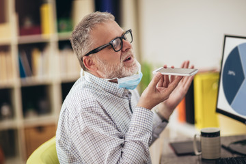 Business man working from home, wear a protective mask. Quarantine due coronavirus pandemic. Stay at home.