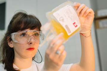 A nurse with goggles in hospital with blood products. infusion of donor blood in clinic