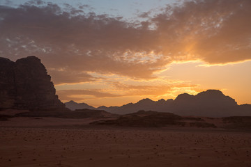 Fototapeta na wymiar Beautiful sunset in the desert. View from the cliff. Taken in Jordan in March 2020