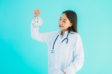 Portrait beautiful young asian doctor woman with clock or alarm