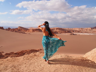 Girl model with long black hair in the long blue dress, Moon Valley, Atacama Desert, San Pedro de Atacama, Chile