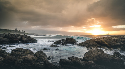 Beautiful waves and sunset in tropical ocean. Hawaiian reef and cove on Oahu. 
