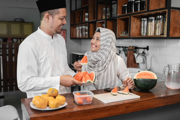 man and muslim woman having some fruit for break fasting dinner