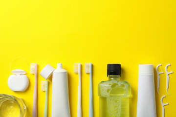 Tools for dental care on yellow background, space for text