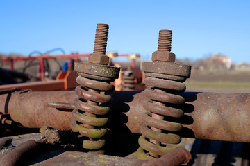 Rusty bolts and nuts on agricultural machinery