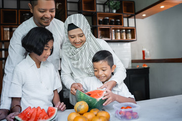 kids help their muslim parent preparing for break fasting dinner