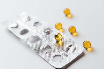Yellow pills in a pack. On a white isolated background. Top view.