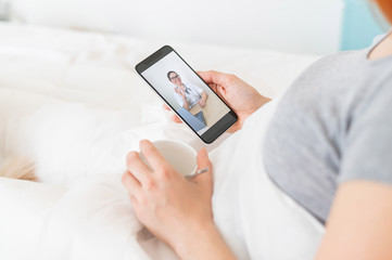 A woman is quarantined at home and is conducting a video conference with a virologist. The patient...