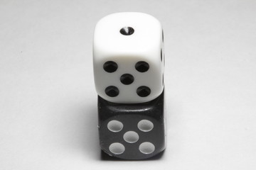 Two dice on a white background. White and black dice on a white background. Isolated dice close up.