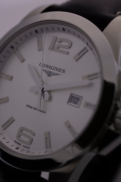 Saint-Imier, Switzerland 31.03.2020 - Closeup image of Longines watch isolated stainless steel case white clock face dial leather strap selective focus swiss quartz mechanical watch swiss made