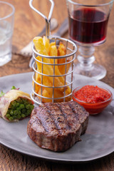closeup of grilled steak with french fries