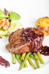 slices of a steak on wood with rosemary
