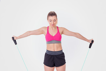 Young woman working out with rubber bands