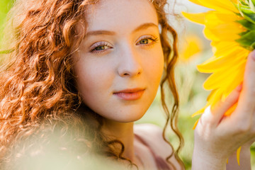 Redhair girl in sunflowers