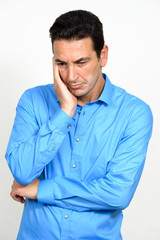 Portrait of stressed mature businessman looking down