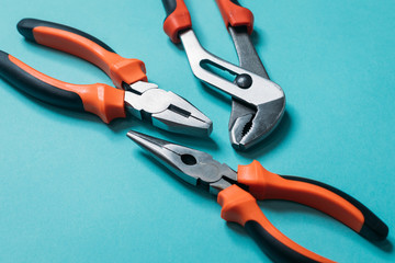 group a bunch of tools with orange handles on a blue background laid out neatly close