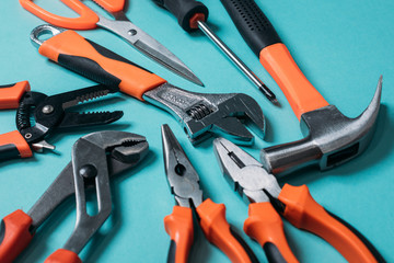 group bunch of tools with orange handles on a blue background close