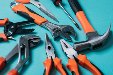 group bunch of tools with orange handles on a blue background close