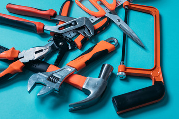 group bunch of tools with orange handles on a blue background close