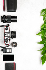 Set of photo accessories with a retro camera on a light background.Travel vacation concept. Summer background. Top view copy space.