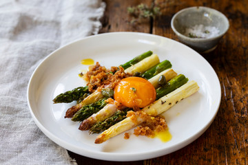 Roasted white and green aspatagus with capers and mustard dressing and cured egg yolk