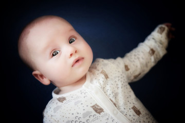 portrait of a baby with blue bokeh background