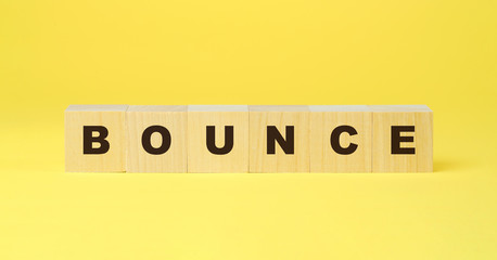 bounce word on wooden blocks isolated yellow background