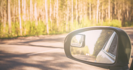 View of side mirror car on country road