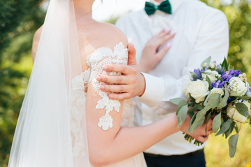 the groom hugs the bride