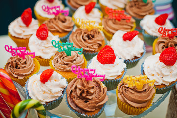 Birthday party. Plate with bright cupcakes