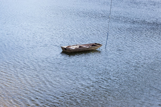 Little boat in the middle of the dam