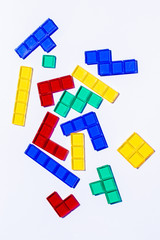 Colorful mixed square blocks on white background, high contrast colours, red blue yellow and green transparent tiles, game for kids, copy space, plenty of text room