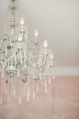 sophisticated chandelier empire style with glass crystals. A photo with a blurred background.
