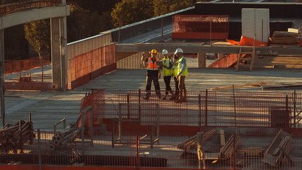 Aerial View: Diverse Team of Specialists Inspect Commercial, Industrial Building / Skyscraper...