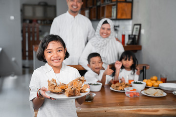 asian kids carrying some menu for iftar dinner with family