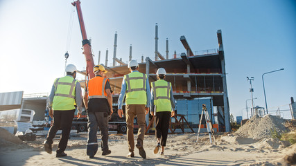 Diverse Team of Specialists Inspect Commercial, Industrial Building Construction Site. Real Estate...
