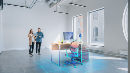 In Empty New Office: Female Interior Designer and Male Office Architect Talk, Use Augmented Reality Software on Digital Tablet Computer to Choose and Place 3D Furniture. VFX Special Effects