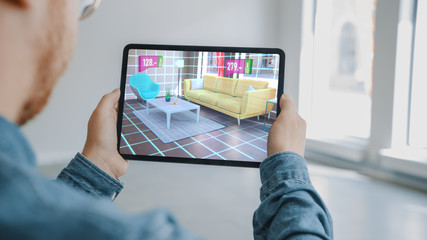 Decorating Apartment: Man Holding Digital Tablet with AR Interior Design Software Chooses 3D...