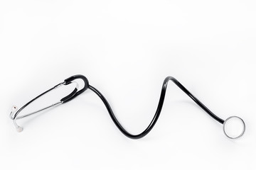 Photo of black medical stethoscope over white background.