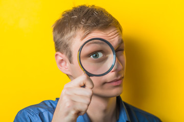 Man looking through a magnifying glass