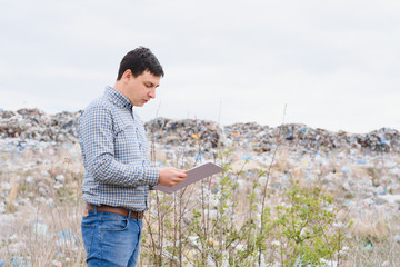 Environmental activist near the landfill. Keeping the environment clean. Ecological problems. Recycling