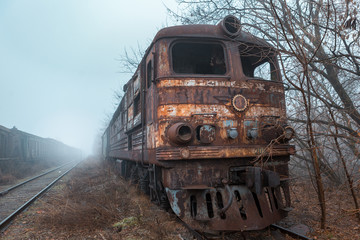 
old soviet train stands in the fog
