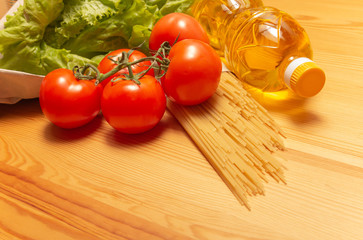Food delivery service. Healthy food on wooden table. Buy online during quarantine. Tomatos, pasta, sunflower oil, salad. High quality photo. Stay home, be safe.