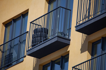 Four car tires are stored on the balcony