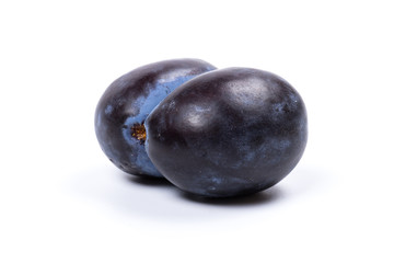 Fresh blue plums, isolated on white background, in close-up.