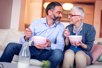 Mature couple have breakfast at home