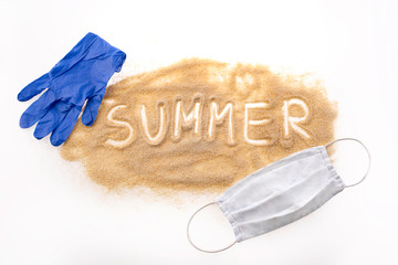 Brown sand on a white background. The inscription SUMMER on the hub, a protective mask around the sand and blue gloves. A vision of summer in 2020 during the Coronavirus pandemic. Summer in Covi-19