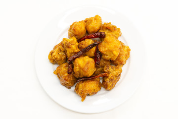 Chinese General Tso's Chicken on white background. General Tso's chicken is a sweet deep-fried chicken dish that is served in North American Chinese restaurants.